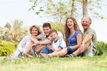 simsearch:400-07426233,k - Happy family siiting in the park and smiling at camera Stock Photo - Budget Royalty-Free & Subscription, Code: 400-04209139