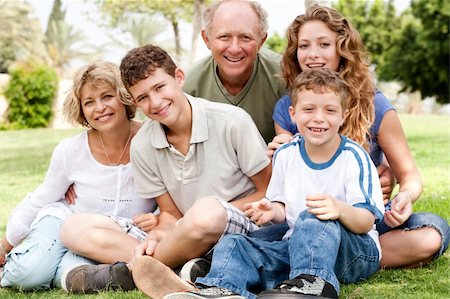 simsearch:400-07426233,k - Portrait of happy family of five smiling at camera, relaxing in park Stock Photo - Budget Royalty-Free & Subscription, Code: 400-04209141