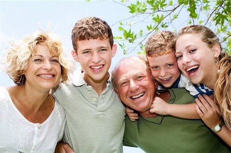 simsearch:400-07426233,k - Close-up shot of a happy family in the park looking at camera Stock Photo - Budget Royalty-Free & Subscription, Code: 400-04209153