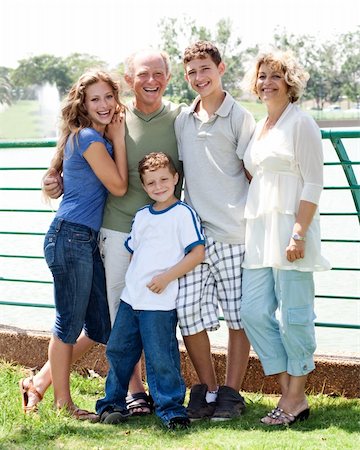 simsearch:400-07426233,k - Happy family posing infront of the lake on a sunny day Stock Photo - Budget Royalty-Free & Subscription, Code: 400-04209164