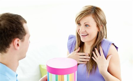 simsearch:400-04195864,k - Attentive man giving a present to his girlfriend at home Stock Photo - Budget Royalty-Free & Subscription, Code: 400-04209400