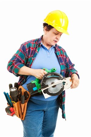 female plumber - Female contruction worker trying to figure out how to use a circular saw. Stock Photo - Budget Royalty-Free & Subscription, Code: 400-04200030