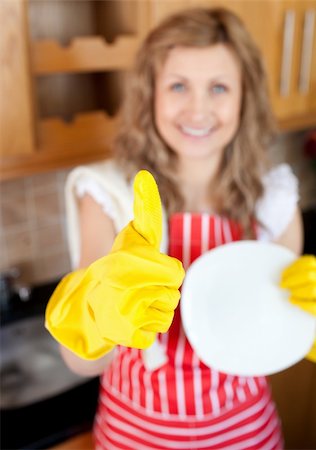 simsearch:400-04202340,k - Cheerful woman with thumb up drying dish in a kitchen Stock Photo - Budget Royalty-Free & Subscription, Code: 400-04201203