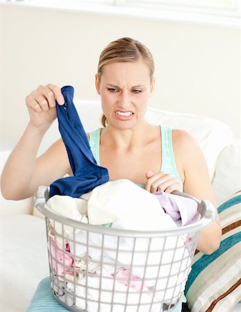 simsearch:400-08693600,k - Unhappy woman doing her laundry at home Stock Photo - Budget Royalty-Free & Subscription, Code: 400-04202052