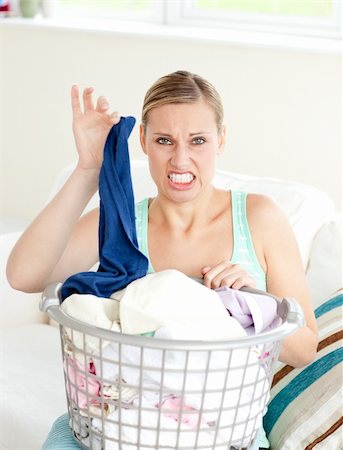 simsearch:400-08693600,k - Disgusted woman doing her laundry at home Stock Photo - Budget Royalty-Free & Subscription, Code: 400-04202053