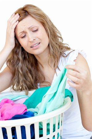 simsearch:400-08693600,k - Disapointed woman doing laundry against a white background Stock Photo - Budget Royalty-Free & Subscription, Code: 400-04202389