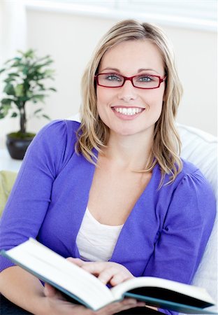 simsearch:400-04418460,k - Portrait of an attractive woman with glasses reading a book sitting on a sofa Stock Photo - Budget Royalty-Free & Subscription, Code: 400-04203023