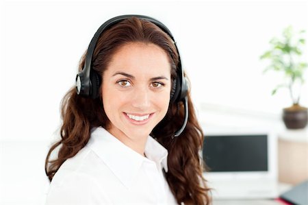 Hispanic businesswoman with earpiece on in her office Stock Photo - Budget Royalty-Free & Subscription, Code: 400-04217193