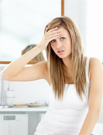 Attractive woman having a headache in the bathroom at home Stock Photo - Budget Royalty-Free & Subscription, Code: 400-04217647