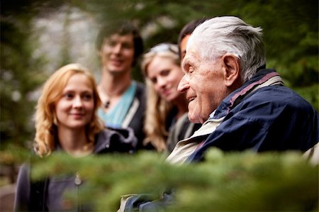 An elderly man telling stories to a group of young people Stock Photo - Budget Royalty-Free & Subscription, Code: 400-04217993