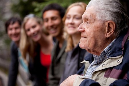 An elderly man telling stories to a group of young people in the forest Stock Photo - Budget Royalty-Free & Subscription, Code: 400-04218003