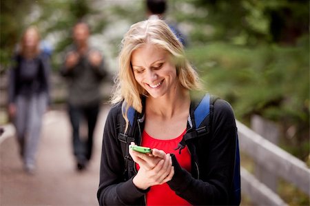 A young woman reading a friendly text while outdoors Stock Photo - Budget Royalty-Free & Subscription, Code: 400-04218012