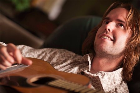 simsearch:400-04863651,k - Young Musician Plays His Accustic Guitar under Dramatic Lighting. Stock Photo - Budget Royalty-Free & Subscription, Code: 400-04219119