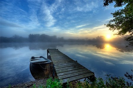 simsearch:400-04756224,k - sunrise at the pier with a boat and with a slight haze Stock Photo - Budget Royalty-Free & Subscription, Code: 400-04210653