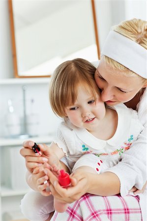 Charming mother making her little daughter's nails in the bathroom Stock Photo - Budget Royalty-Free & Subscription, Code: 400-04210820