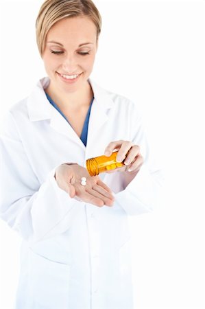 simsearch:6109-06005907,k - Charming young doctor holding pills against a white background Stock Photo - Budget Royalty-Free & Subscription, Code: 400-04212862