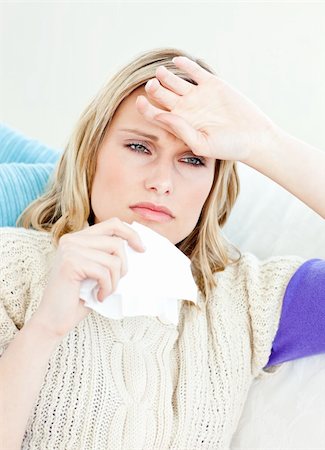 simsearch:400-05716904,k - Ill woman holding a tissue sitting on a sofa at home Stock Photo - Budget Royalty-Free & Subscription, Code: 400-04212889