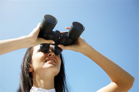 closeup photo, young woman looking through binoculars, sunny light f/x Stock Photo - Budget Royalty-Free & Subscription, Code: 400-04213235