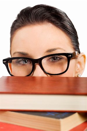 simsearch:400-04860880,k - pretty student with big glasses coming up with her smiling eyes from a pile of book Stock Photo - Budget Royalty-Free & Subscription, Code: 400-04213416