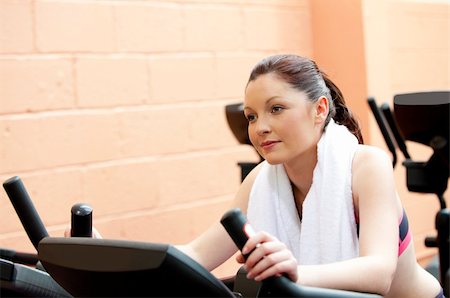 simsearch:400-05677910,k - Beautiful woman training on a bicycle in a fitness center Photographie de stock - Aubaine LD & Abonnement, Code: 400-04224760