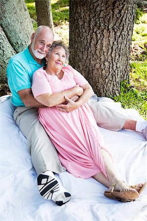 simsearch:400-04208630,k - Romantic senior couple relaxes together outdoors under the trees. Stock Photo - Budget Royalty-Free & Subscription, Code: 400-04226423