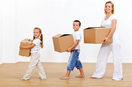 Family moving in to a new home carrying cardboard boxes Stock Photo - Budget Royalty-Free & Subscription, Code: 400-04227488
