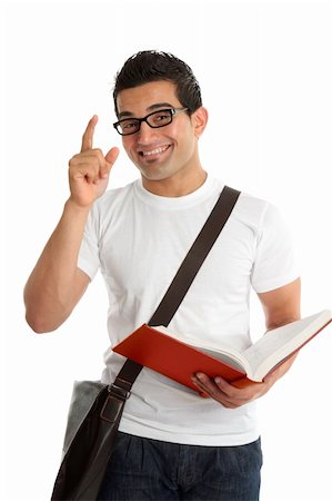 A smiling male university or college student with a question or answer.  He is holding an open textbook.  White background. Foto de stock - Super Valor sin royalties y Suscripción, Código: 400-04227539