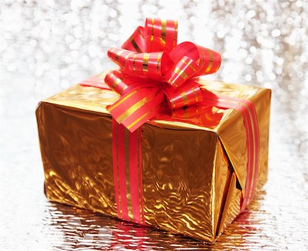 simsearch:400-05381288,k - Gift in the golden foil against the bright background Stock Photo - Budget Royalty-Free & Subscription, Code: 400-04228616
