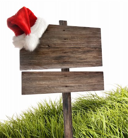 simsearch:400-04229535,k - Weathered wooden sign with santa hat and grass on white Photographie de stock - Aubaine LD & Abonnement, Code: 400-04229534