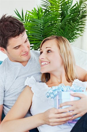 simsearch:400-04195864,k - beautiful woman looking at his boyfriend after receiving a gift both in the living-room Stock Photo - Budget Royalty-Free & Subscription, Code: 400-04220784