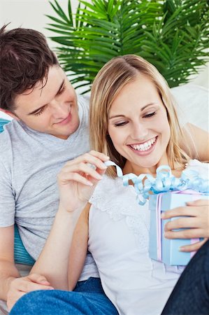 simsearch:400-04739802,k - Couple lying on the sofa with a present Stock Photo - Budget Royalty-Free & Subscription, Code: 400-04220787