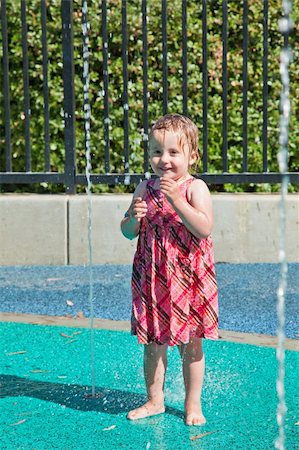 Cute little European toddler girl having fun with water at the playground in park Stock Photo - Budget Royalty-Free & Subscription, Code: 400-04221763