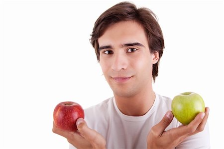 Portrait of a young man with two apples in their hands: green and red. Concept of choice Stock Photo - Budget Royalty-Free & Subscription, Code: 400-04223357