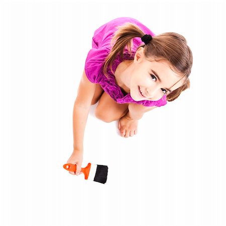 Top view of a happy girl sitting on floor holding a paint-brush Stock Photo - Budget Royalty-Free & Subscription, Code: 400-04234029