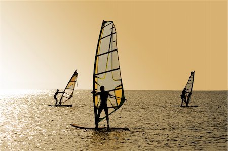 simsearch:400-03992760,k - Silhouettes of three windsurfers on waves of a gulf Stock Photo - Budget Royalty-Free & Subscription, Code: 400-04234203