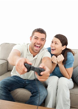 simsearch:400-05751526,k - Cheerful woman encouraging her boyfriend playing video game at home Stock Photo - Budget Royalty-Free & Subscription, Code: 400-04237351