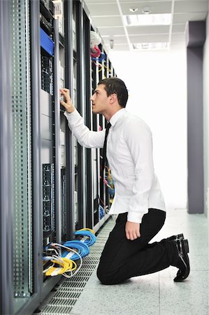 simsearch:400-04239432,k - young handsome business man  engeneer in datacenter server room Stock Photo - Budget Royalty-Free & Subscription, Code: 400-04239415