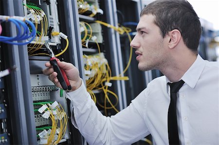 simsearch:400-05291415,k - young handsome business man  engeneer in datacenter server room Stock Photo - Budget Royalty-Free & Subscription, Code: 400-04239433