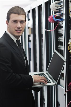 simsearch:400-05291415,k - young engeneer business man with thin modern aluminium laptop in network server room Stock Photo - Budget Royalty-Free & Subscription, Code: 400-04239449