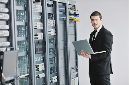 simsearch:400-05881495,k - young engeneer business man with thin modern aluminium laptop in network server room Stock Photo - Budget Royalty-Free & Subscription, Code: 400-04239443