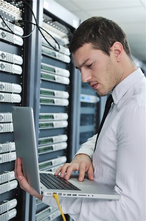 simsearch:400-05291415,k - young engeneer business man with thin modern aluminium laptop in network server room Stock Photo - Budget Royalty-Free & Subscription, Code: 400-04239451