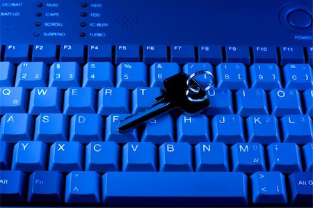 simsearch:695-05771662,k - Key rests upon computer keyboard , blue background Stock Photo - Budget Royalty-Free & Subscription, Code: 400-04230435