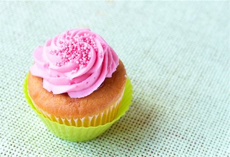 simsearch:400-04764403,k - Fresh vanilla cupcake in green cup with strawberry icing on decorative background Stock Photo - Budget Royalty-Free & Subscription, Code: 400-04230758
