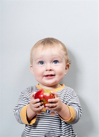 simsearch:400-04594888,k - Charming baby with apple on a grey background Stock Photo - Budget Royalty-Free & Subscription, Code: 400-04230769