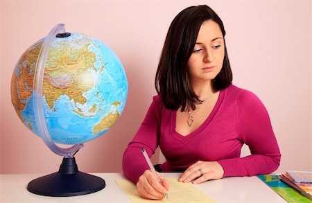 simsearch:400-06084780,k - Teacher at her desk with the globe and books Stock Photo - Budget Royalty-Free & Subscription, Code: 400-04231146