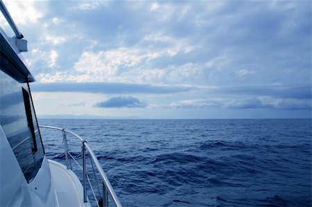 simsearch:400-07748817,k - Boat sailing in cloudy stormy day blue ocean sea, yacht side view Stock Photo - Budget Royalty-Free & Subscription, Code: 400-04231364