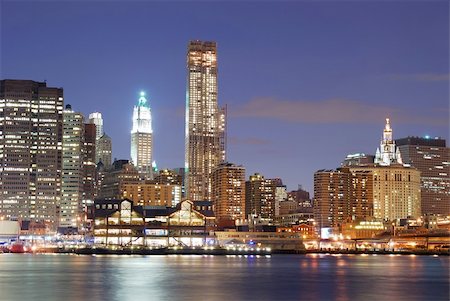 simsearch:400-07424733,k - New York City Manhattan skyline with office skyscrapers building in at dusk illuminated with lights at night over Hudson River Stock Photo - Budget Royalty-Free & Subscription, Code: 400-04240618