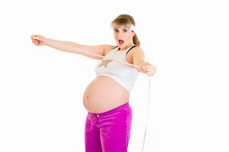 simsearch:400-04798379,k - Shocked beautiful pregnant woman holding measure tape isolated on white Stock Photo - Budget Royalty-Free & Subscription, Code: 400-04243264