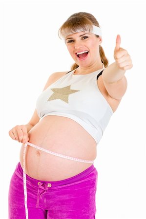 simsearch:400-04798379,k - Smiling pregnant woman holding measure tape and showing thumbs up gesture isolated on white Stock Photo - Budget Royalty-Free & Subscription, Code: 400-04243262