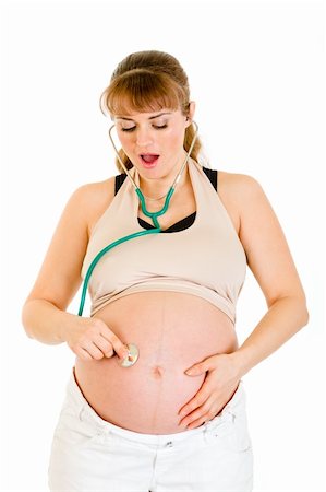 simsearch:400-04817039,k - Surprised pregnant woman holding stethascope on her belly isolated on white Stock Photo - Budget Royalty-Free & Subscription, Code: 400-04243281